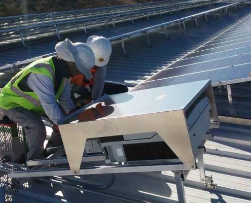 workers testing solar panels